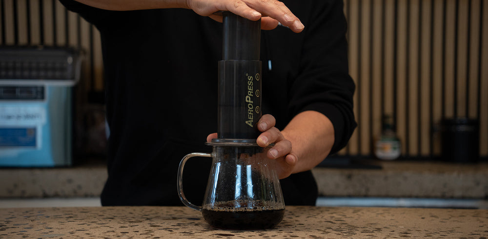 AeroPress pressing coffee into a mug